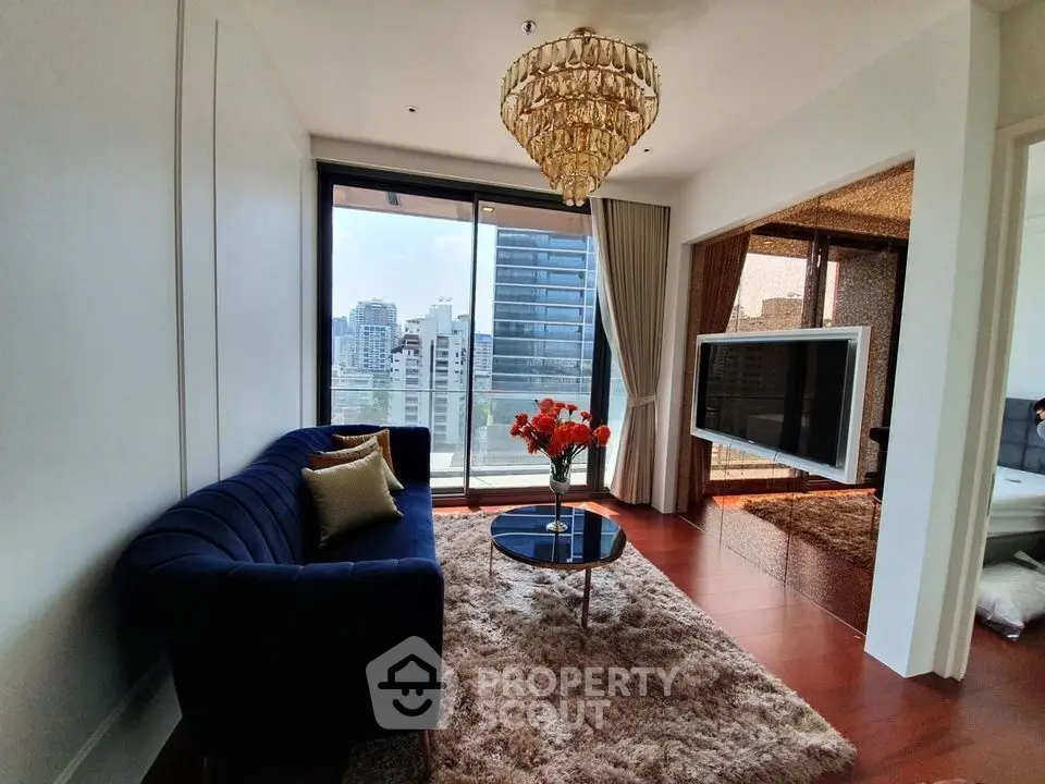 Luxurious living room with elegant chandelier and city view, featuring plush sofa and modern decor.