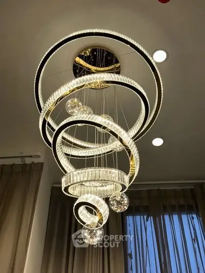 Elegant spiral chandelier in modern interior setting with ceiling lights