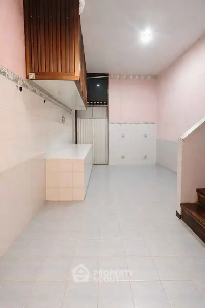 Spacious tiled kitchen with ample storage and wooden cabinetry
