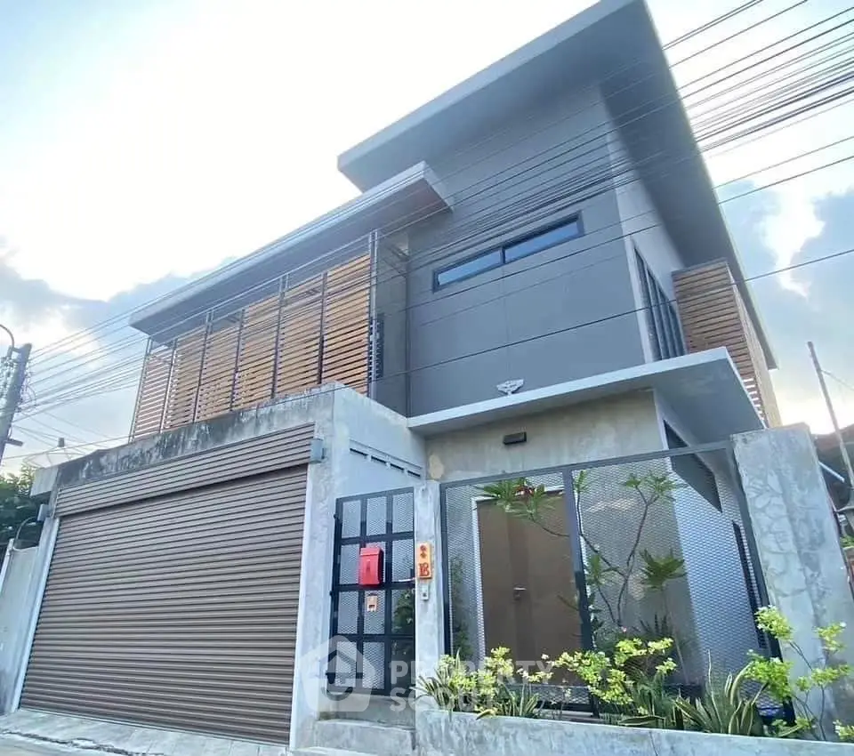 Modern two-story house with sleek design and gated entrance