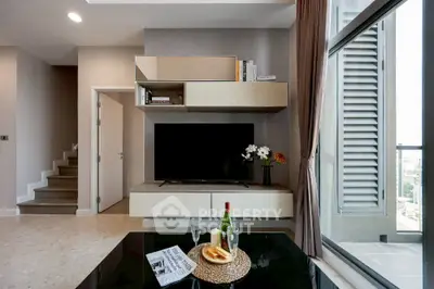 Modern living room with stylish TV unit and balcony view