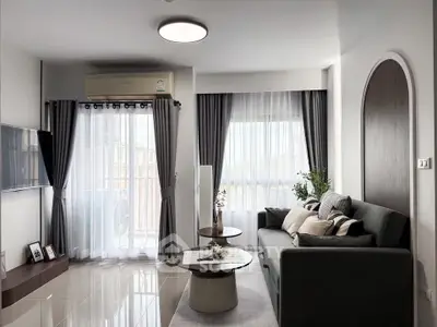 Modern living room with sleek furniture and large windows for natural light