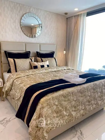 Luxurious bedroom with elegant decor and large window offering natural light.