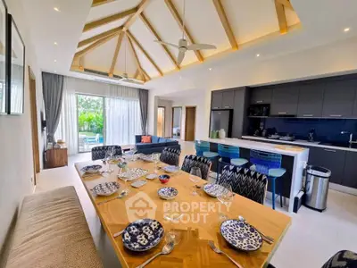 Spacious open-plan kitchen and dining area with modern decor and high ceilings.