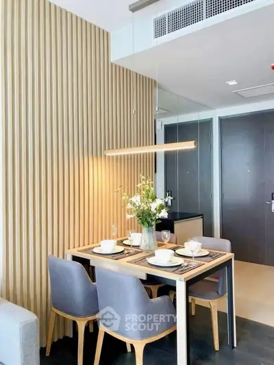 Modern dining area with elegant decor and stylish lighting in a contemporary apartment.