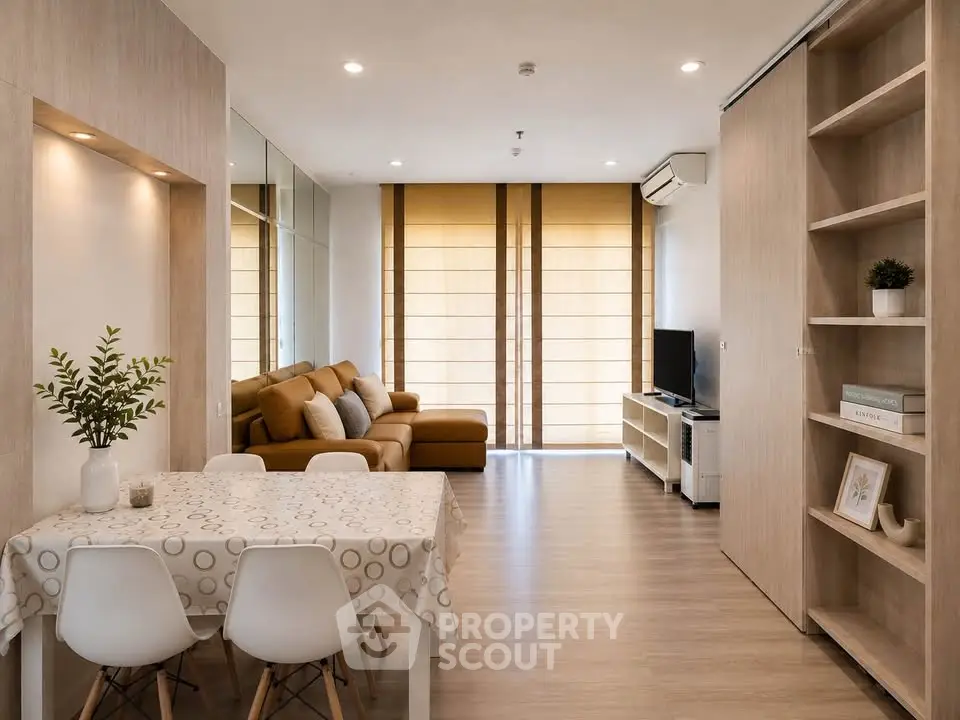Modern living room with stylish decor and natural light, featuring a cozy sofa and dining area.