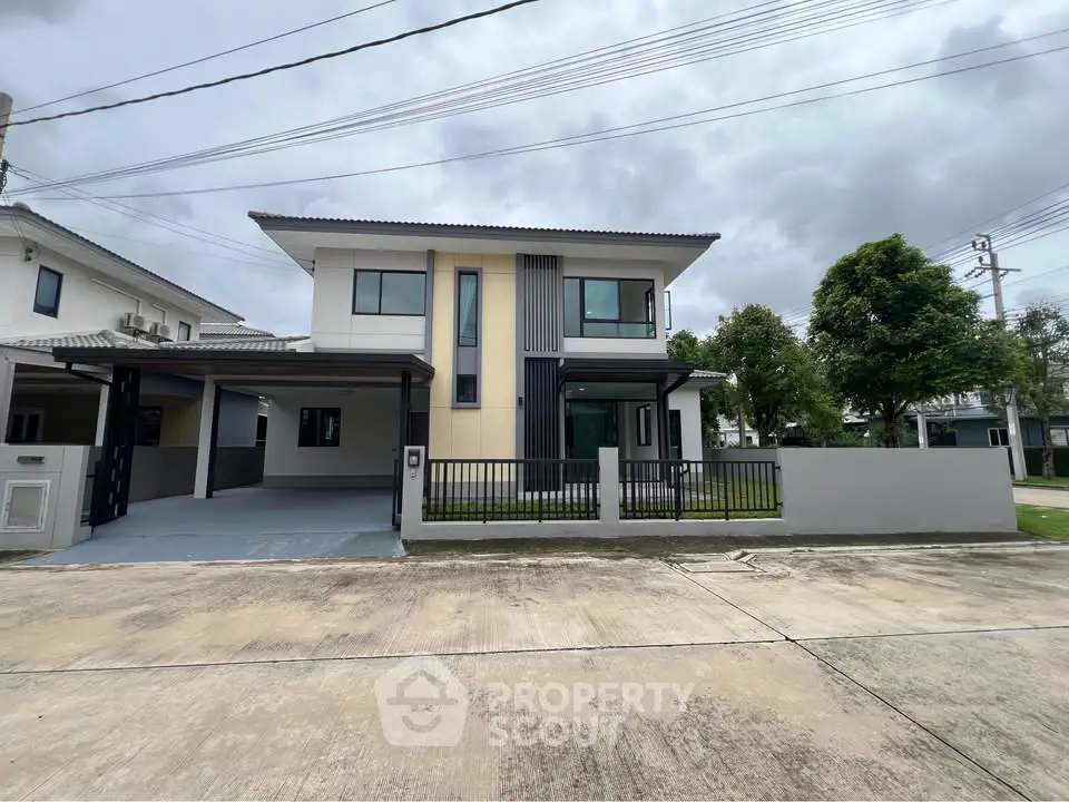 Modern two-story house with sleek design and spacious driveway in a serene neighborhood.