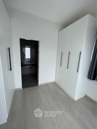 Spacious bedroom with sleek wardrobe and ensuite bathroom