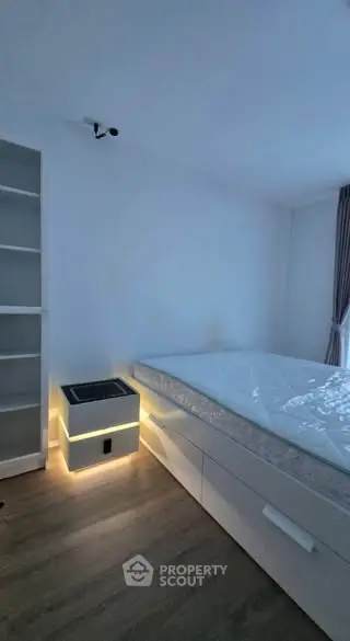 Modern bedroom with sleek design and ambient lighting