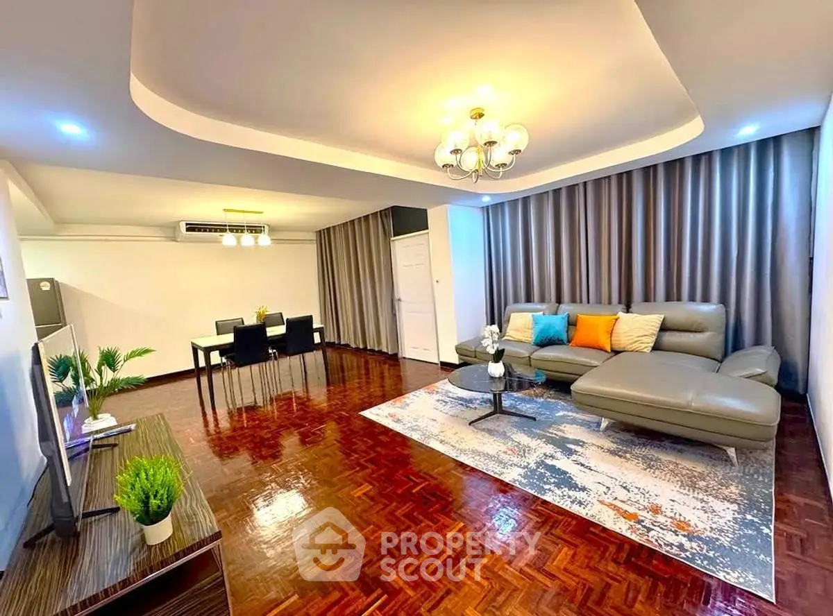 Spacious living room with modern decor and elegant lighting