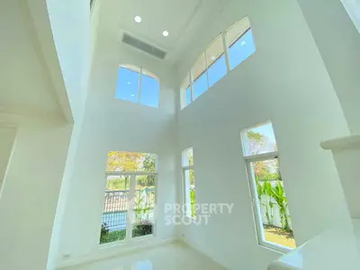 Stunning high-ceiling living room with large windows and abundant natural light