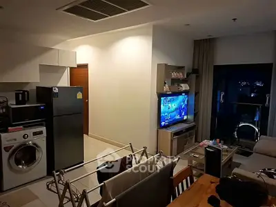 Modern apartment interior with open kitchen and cozy living area featuring a city view.