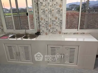 Charming kitchen with scenic view and modern tiled backsplash