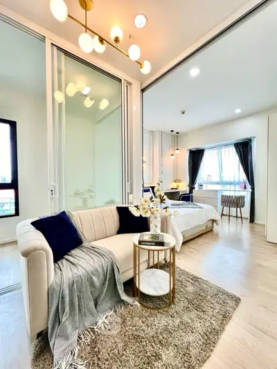 Modern open-plan living room with elegant decor and cozy seating area