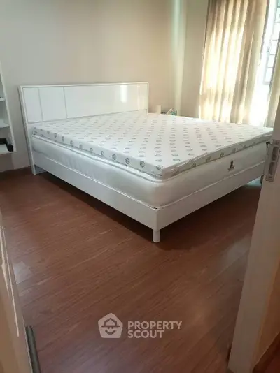 Spacious bedroom with modern bed and natural light