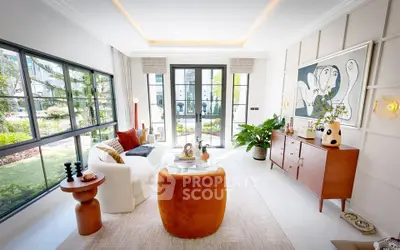 Luxurious living room with modern decor and large windows overlooking garden