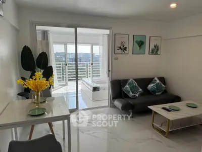 Modern living room with balcony view, stylish decor, and natural light