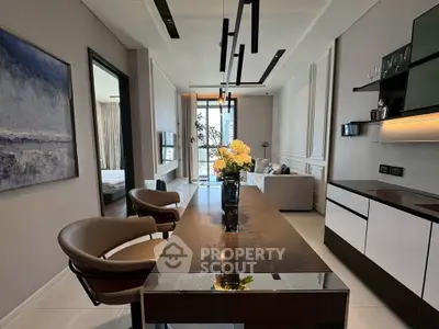 Modern living room with elegant decor and open layout, featuring stylish furniture and natural light.