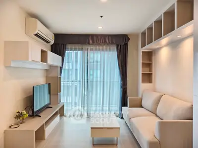 Modern living room with cozy sofa, TV, and stylish shelving, featuring large windows for natural light.