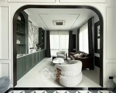 Luxurious living room with elegant marble accents and modern furniture in a sophisticated interior design.