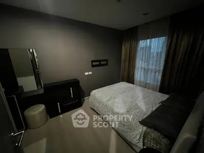 Modern bedroom with city view, featuring elegant decor and natural light.