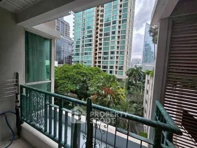 Charming balcony with lush garden view in urban high-rise setting