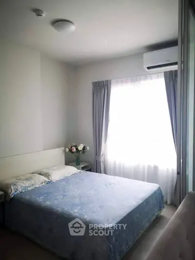 Cozy bedroom with natural light and elegant decor in modern apartment.