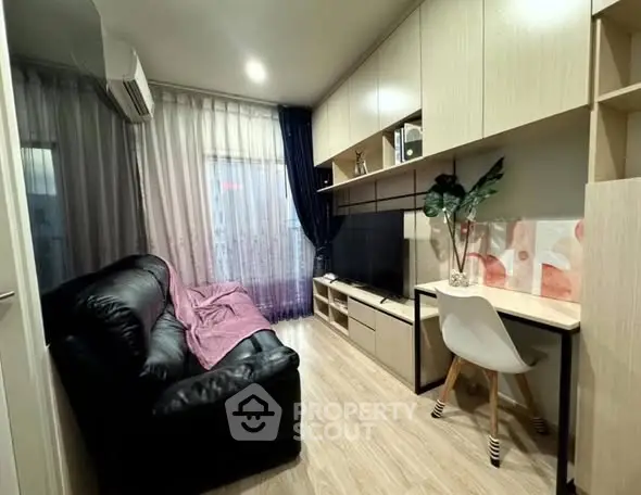 Modern living room with sleek furniture and natural light, perfect for cozy urban living.