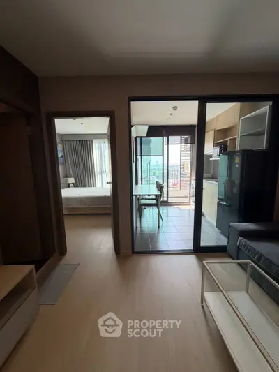 Modern apartment interior with open layout, featuring a cozy living area, sleek kitchen, and bright bedroom.