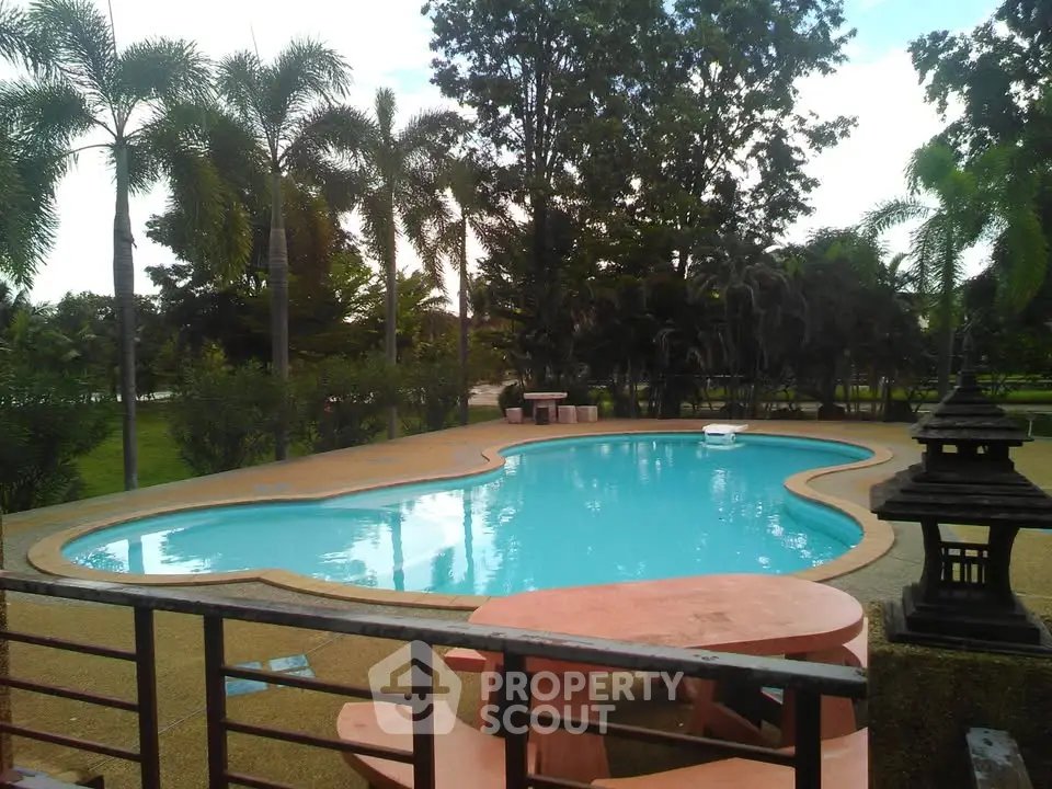 Stunning outdoor pool area with lush greenery and serene ambiance