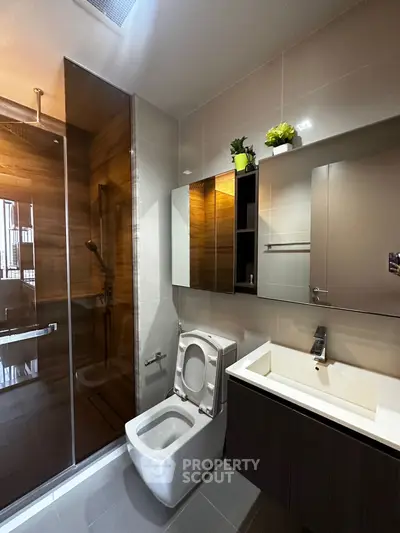 Modern bathroom with sleek fixtures and glass shower enclosure