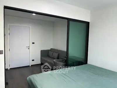 Modern bedroom with sliding glass door to cozy sitting area