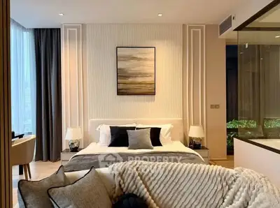 Luxurious modern bedroom with elegant decor and large windows offering natural light.