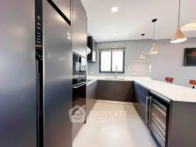 Modern kitchen with sleek black cabinets and island seating