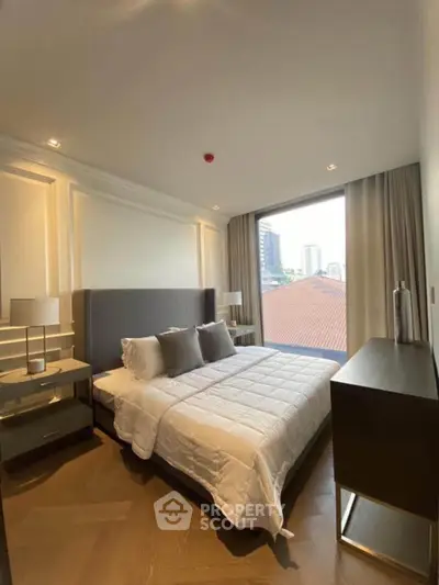 Luxurious bedroom with modern decor and large window offering city view