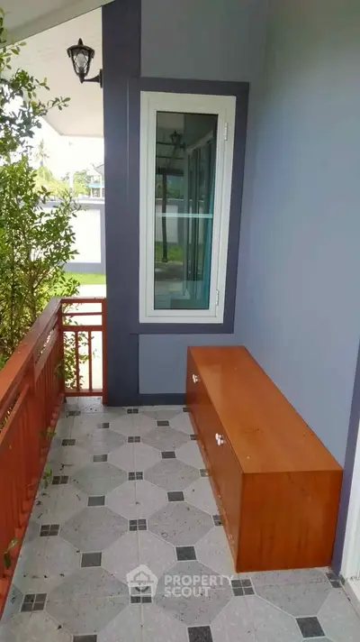 Charming small balcony with wooden bench and modern window design