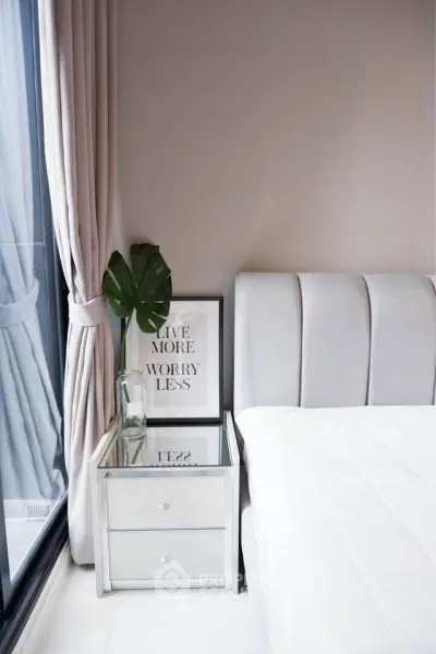 Elegant bedroom with modern decor and large window for natural light
