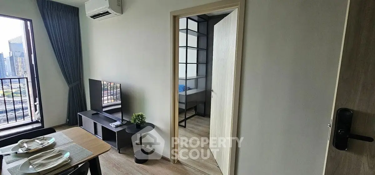 Modern apartment interior with open living room and dining area, featuring city view balcony.