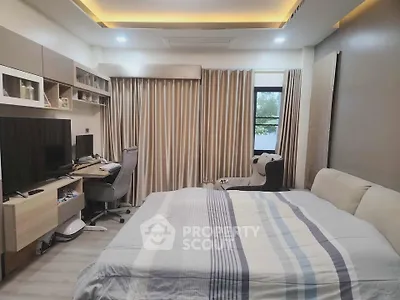 Modern bedroom with cozy bed, stylish desk, and elegant lighting