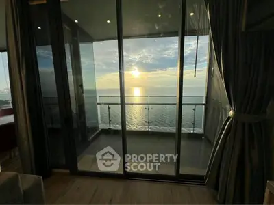 Stunning ocean view from modern apartment balcony at sunset