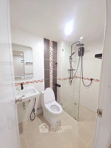 Modern bathroom with glass shower and sleek fixtures in a contemporary home.