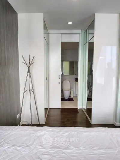 Modern bedroom with ensuite bathroom featuring sleek design and contemporary decor.