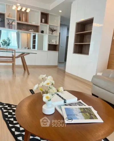 Modern living room with stylish decor and open layout, featuring elegant furniture and natural light.