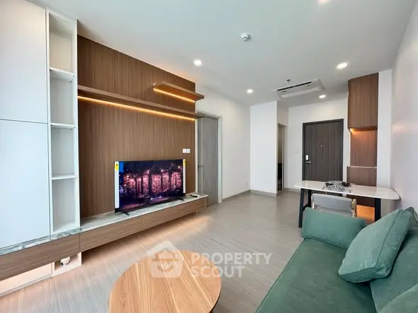 Modern living room with stylish furniture and built-in TV unit in a contemporary apartment.