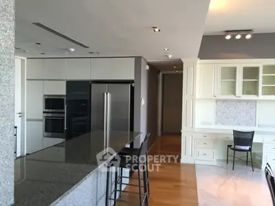 Modern kitchen with sleek appliances and spacious countertop in luxury apartment