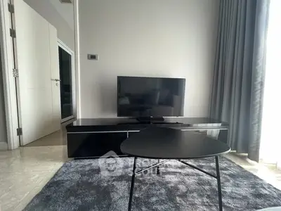 Modern living room with sleek TV setup and stylish furniture