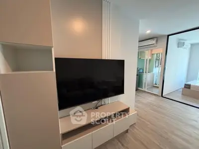 Modern living room with sleek TV setup and stylish storage solutions.