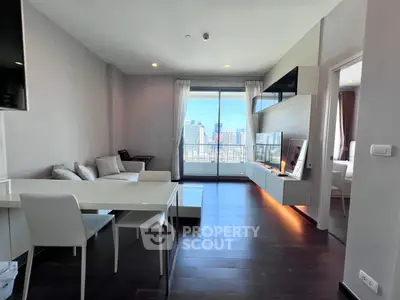 Modern living room with city view, sleek furniture, and large windows for natural light.