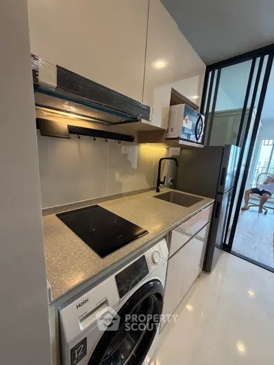 Modern kitchen with sleek appliances and open layout in stylish apartment