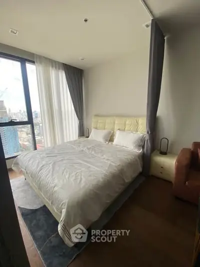 Luxurious bedroom with city view, featuring a cozy bed and elegant curtains.